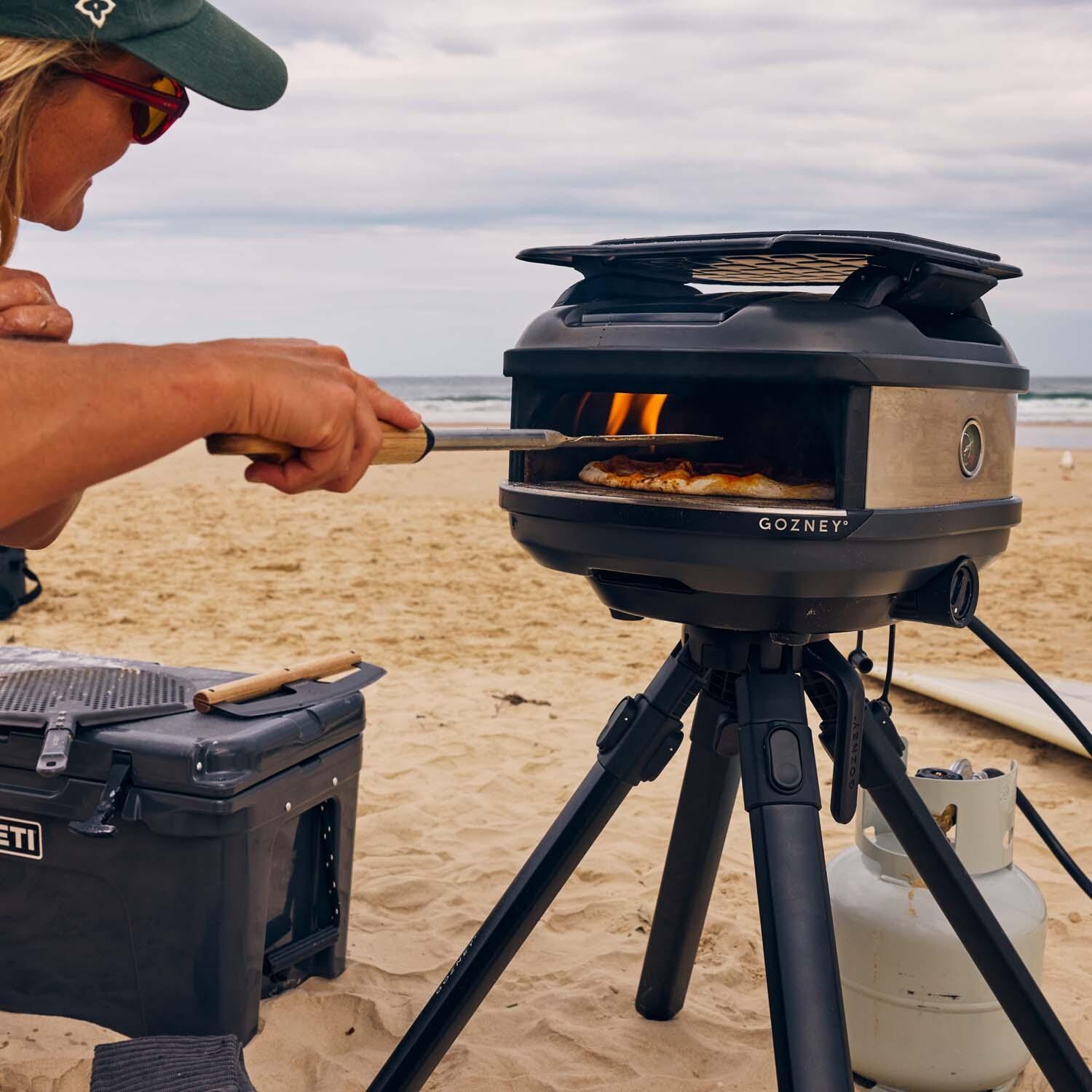 Gozney GTPOBUS1225 Black Tread Propane Pizza Oven Bundle - Cooking on the Beach - Lifestyle thumbnail