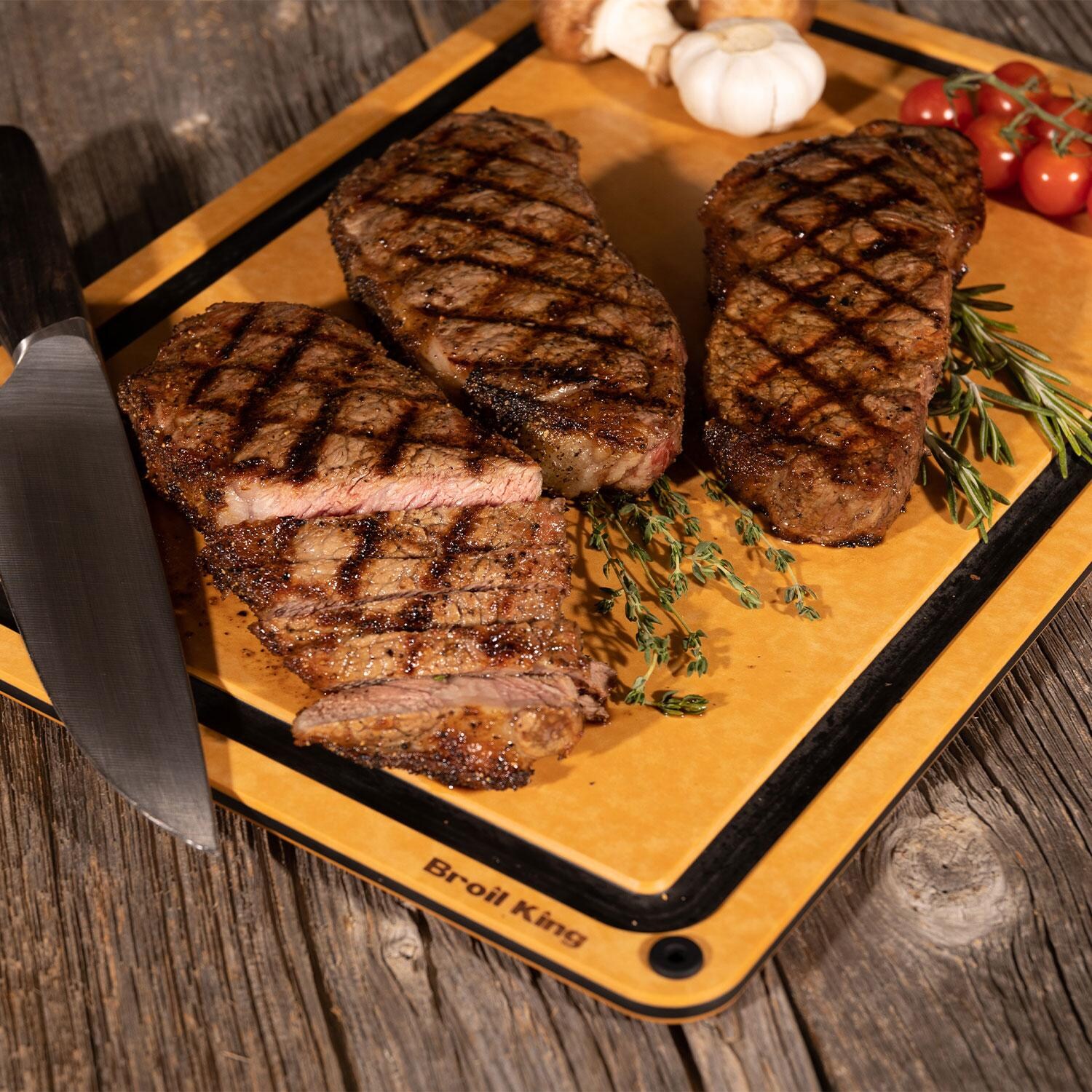 Broil King 68422 Wood Fiber Cutting Board - Ribeyes, Tomatoes, Garlic, & Onions Cut on Board - Lifestyle thumbnail