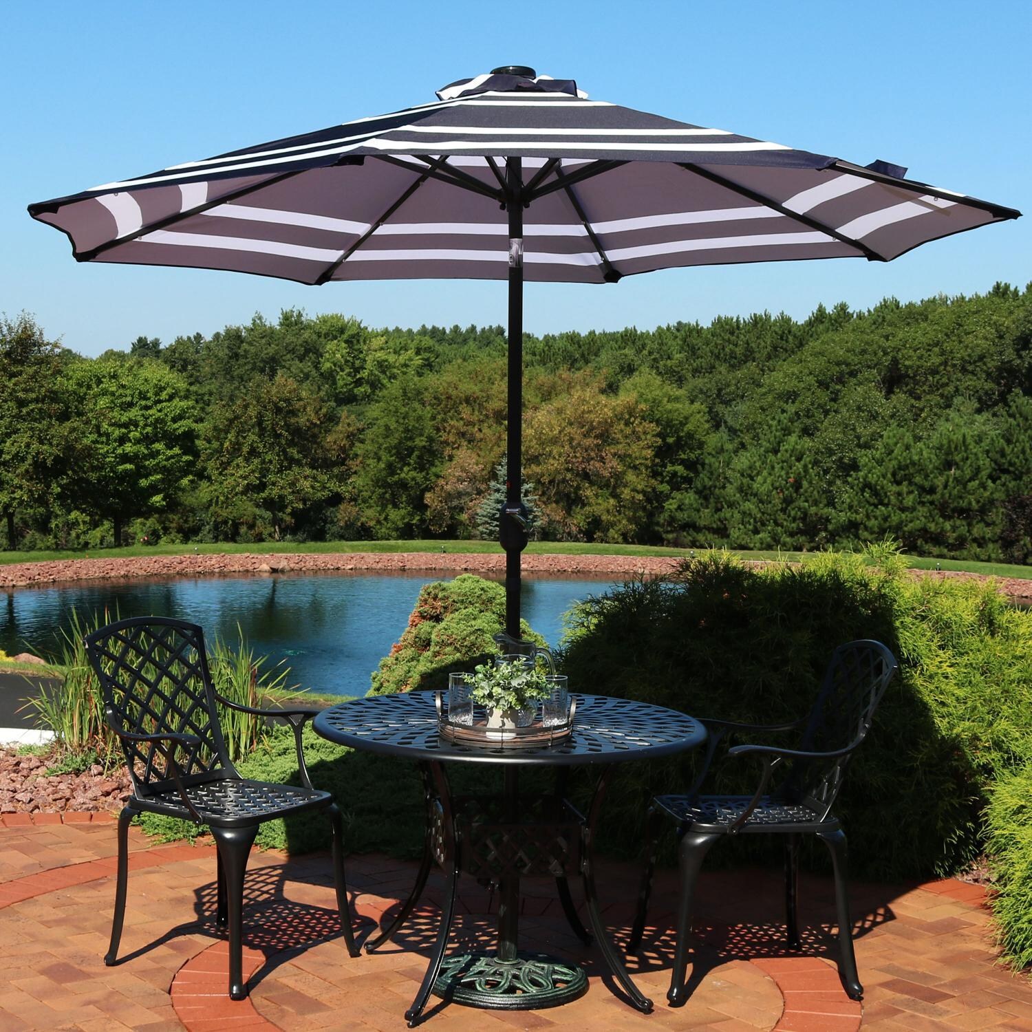 Ultimate Patio 9ft. Solar Lighted Octagonal Patio Umbrella W/ Crank Lift - Navy Blue Stripe Canopy - Lifestyle View thumbnail