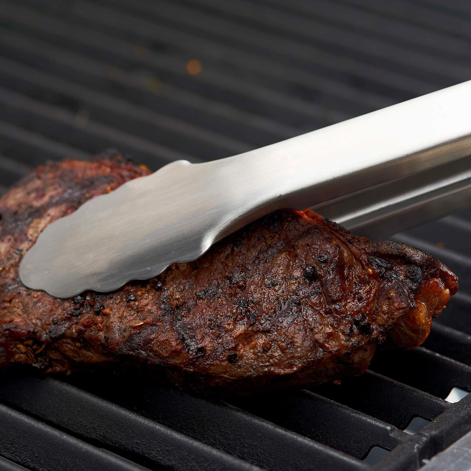 GrillPro 20-in Professional Extra Long Tongs w/ Rubber Grips - 40269 - Holding Steak - Lifestyle thumbnail