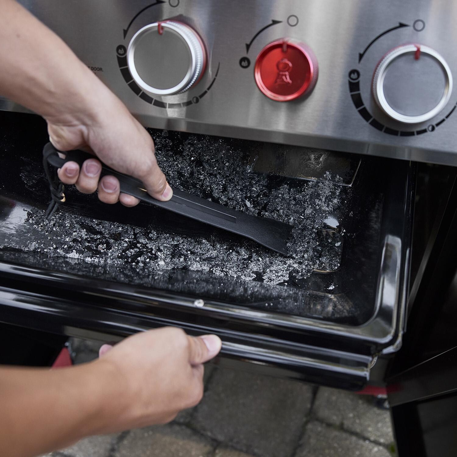 Weber 1500368 GENESIS E-415 Natural Gas Grill in Black - Grease Management System Scraper - Lifestyle