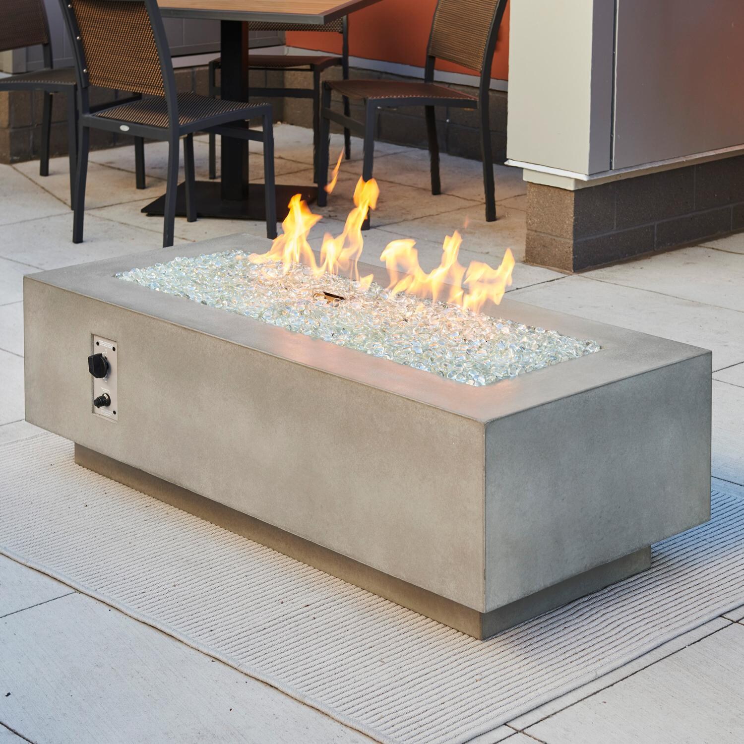Cove 54 Inch Rectangular GFRC Propane Fire Pit Table w/ Electronic Ignition in Natural Gray by The Outdoor GreatRoom Company