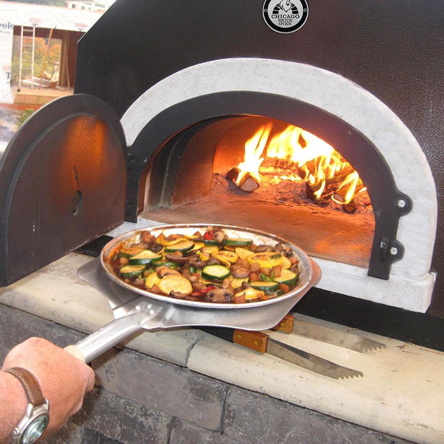 Chicago Brick Oven CBO-750 Countertop Wood Fired Pizza Oven w/ Cover - Copper - Baking Pizza - Lifestyle thumbnail
