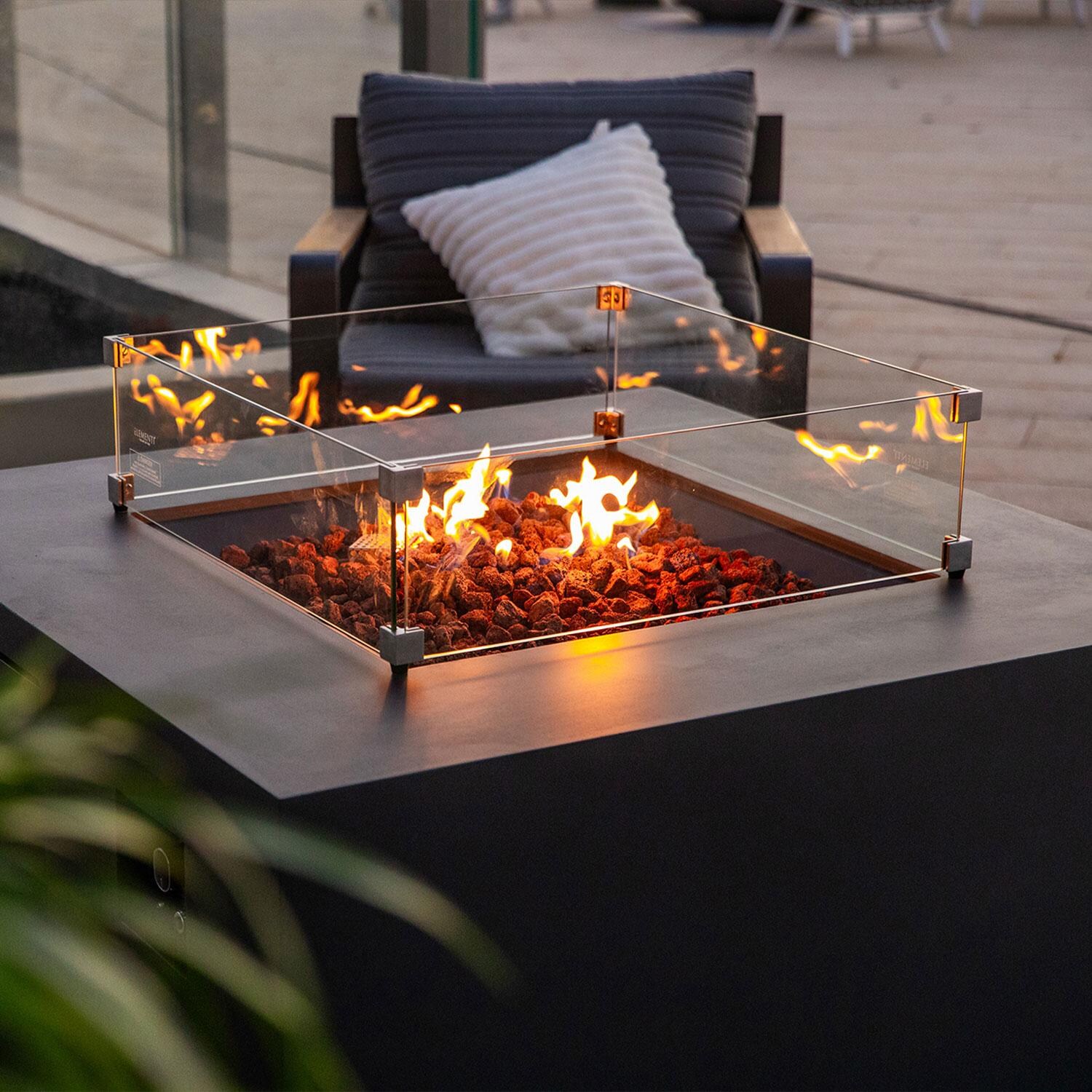 Elementi OFG310DG-LP Rocky 43-in Liquid Propane Concrete Fire Table w/ Hidden Tank in Dark Grey - Wind Guard - On - Lifestyle thumbnail