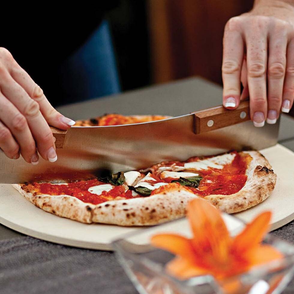 Outset 76615 Acacia Pizza Cutter - Cutting Pizza - Lifestyle thumbnail