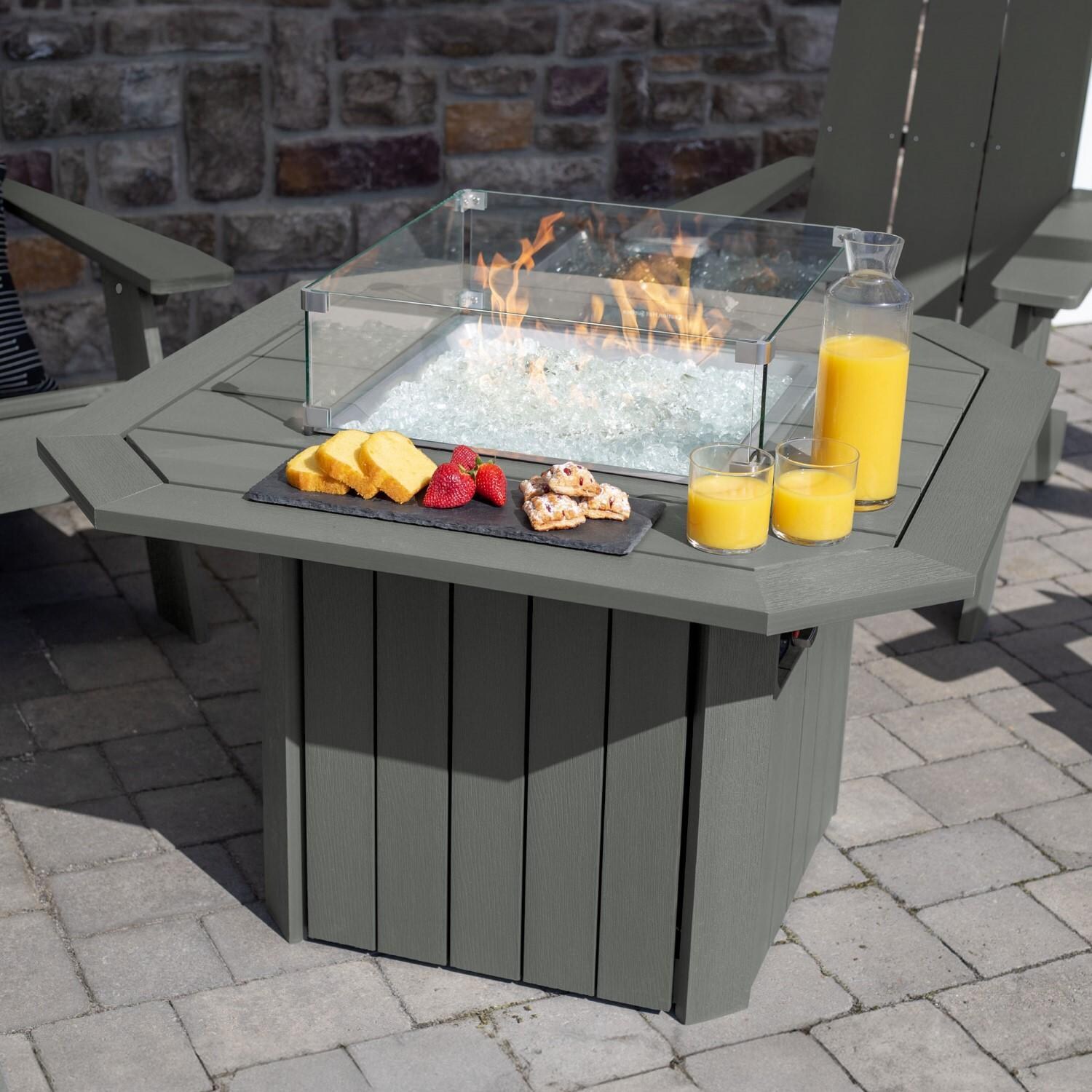 Harborview 5 Pc Adirondack Set W/ Fire Pit Table in Coastal Teak by Lakeview Outdoor Designs - Angled Table View - Lifestyle thumbnail