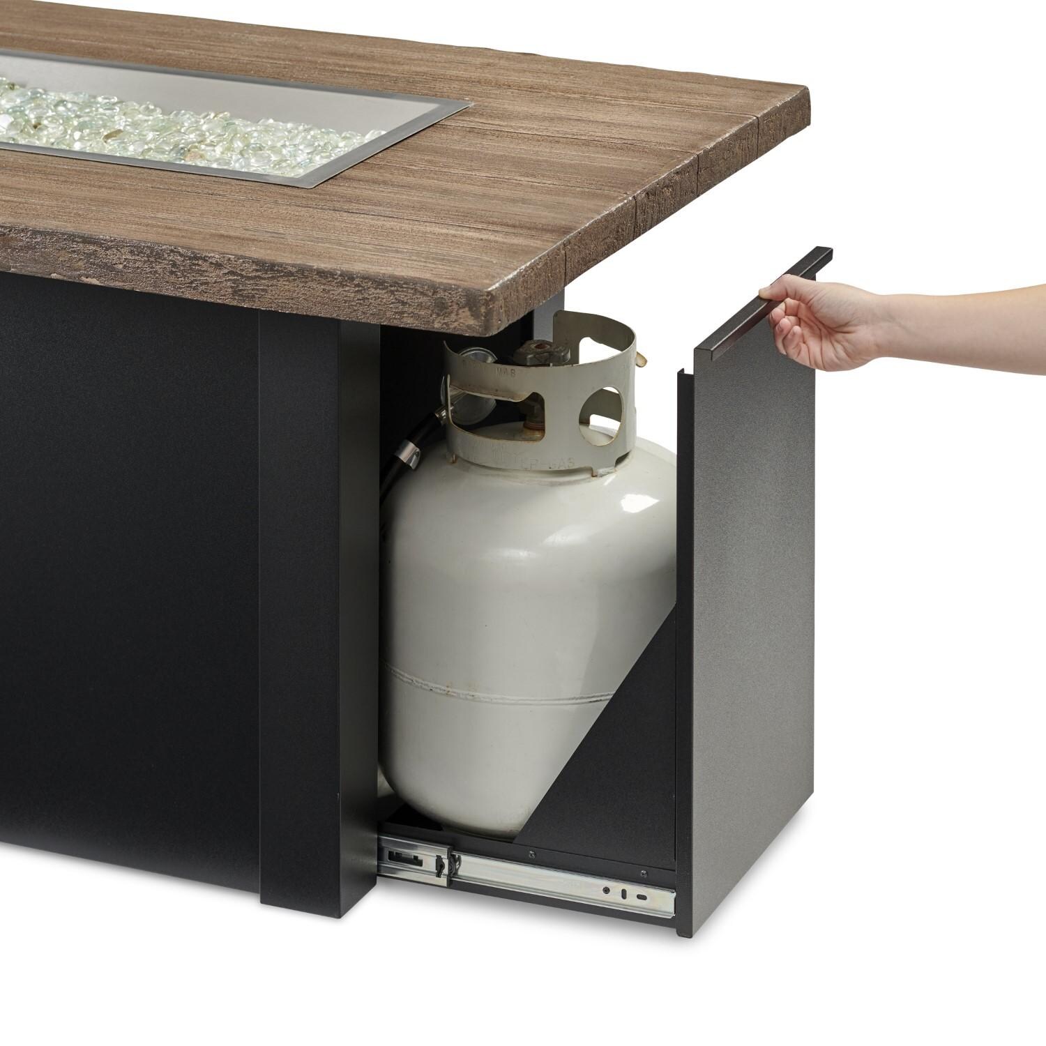 Havenwood 62 Inch Natural Gas Fire Pit Table W/ Driftwood Top & Black Base - Hand Reaching For Tank Drawer - Detail thumbnail