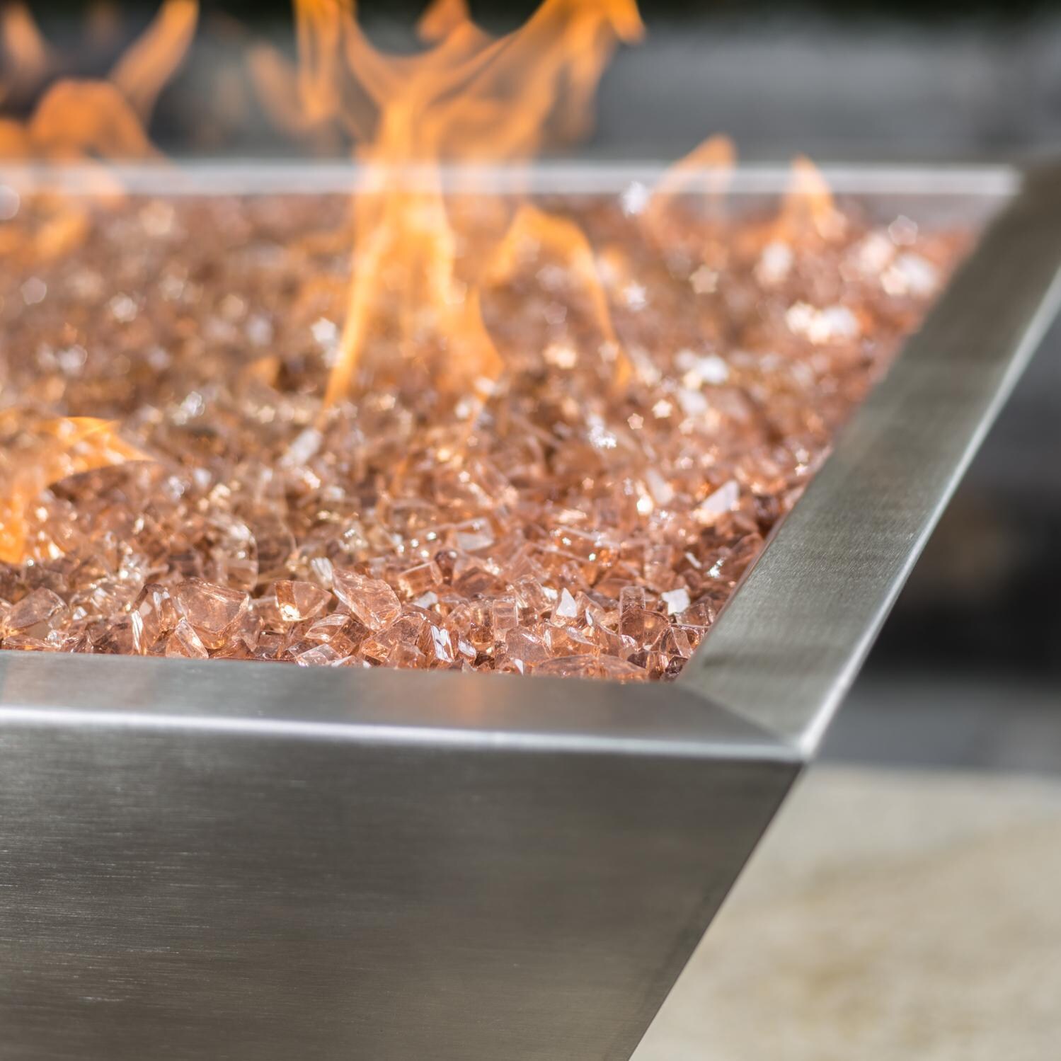 BBQGuys Signature Series Westfalen 24-Inch Square High-Rise Propane Fire Bowl - Stainless Steel - Corner Detail - Shown with 1/2 inch Sunset Amber Non-reflective Fire Glass (Sold Separately) thumbnail