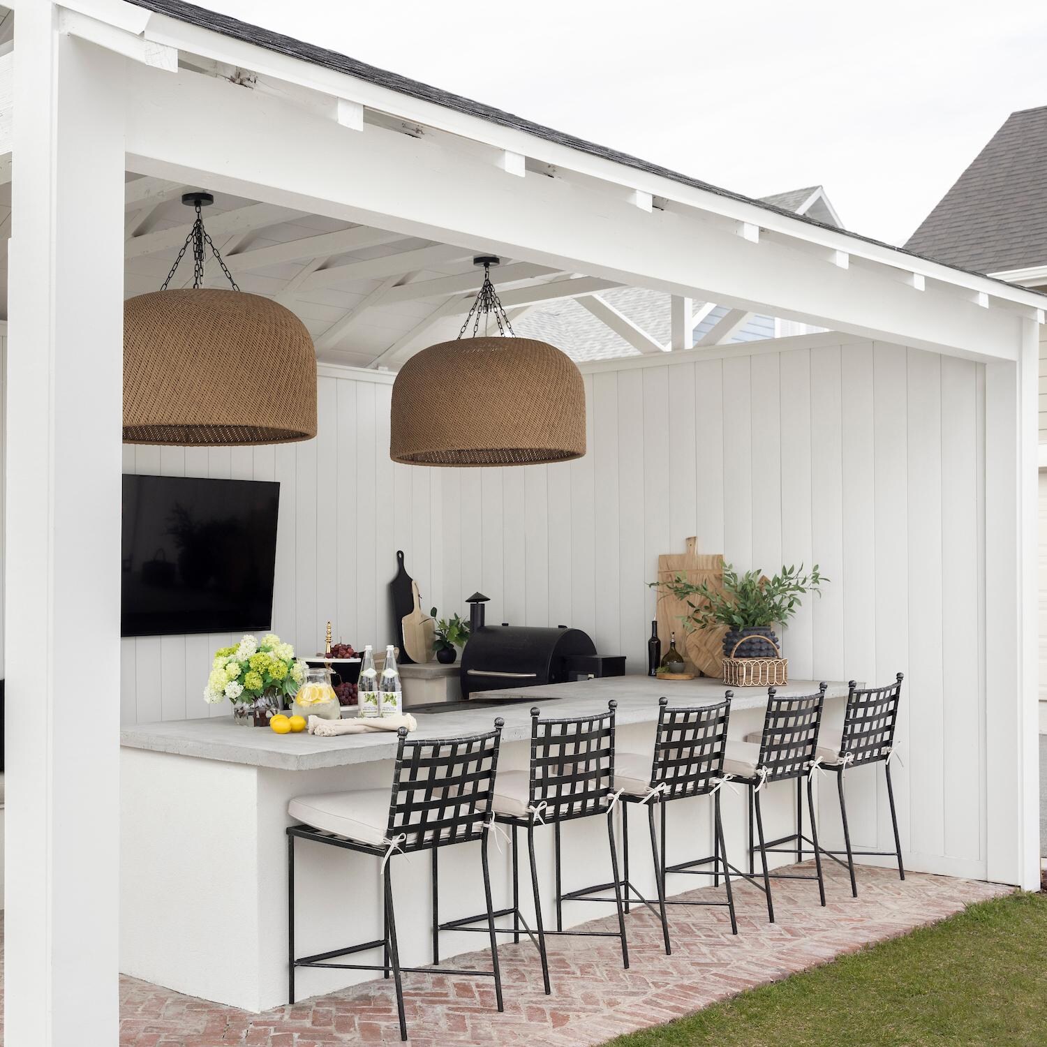 Provence 2 Piece Wrought Iron Patio Bar Stool Set W/ Sunbrella Canvas Flax Cushions By Sunset West - Angled - Lifestyle thumbnail