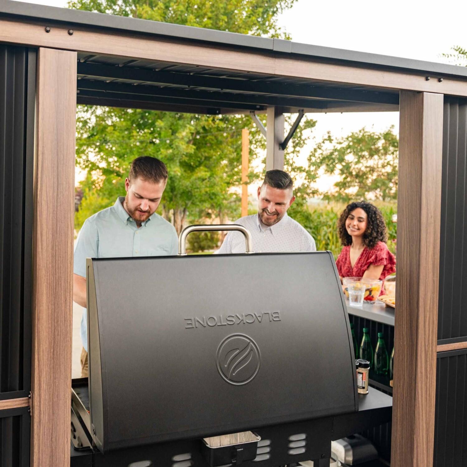 Blackstone 10 x 10-Foot Bar and Griddle/Grill Pavilion - Grilling with Friends - Close Up View - Lifestyle thumbnail