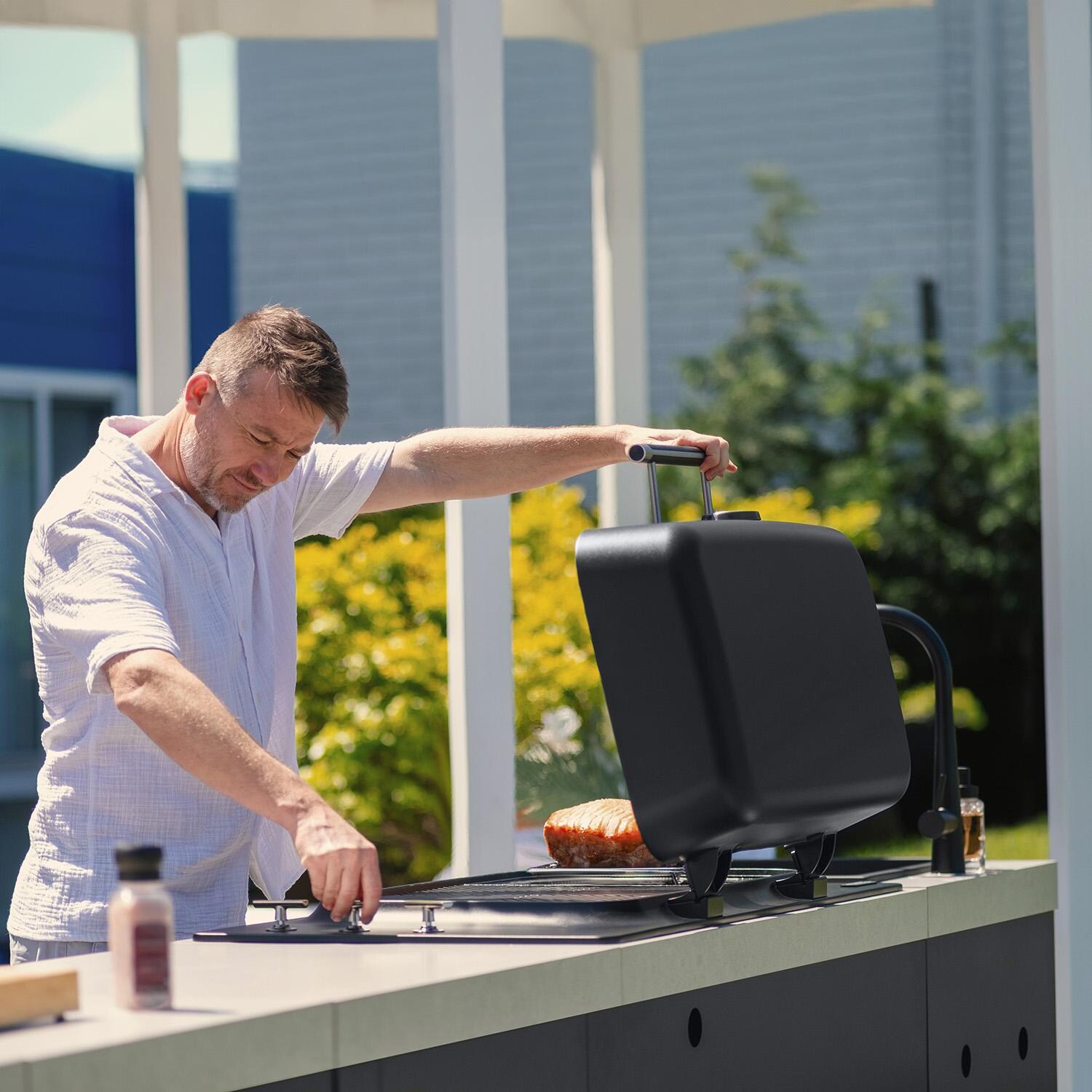 Everdure 9 Ft Outdoor Kitchen Island w/ Marine Grade Aluminum Cabinets in Black - Cooking on Grill - Lifestyle thumbnail