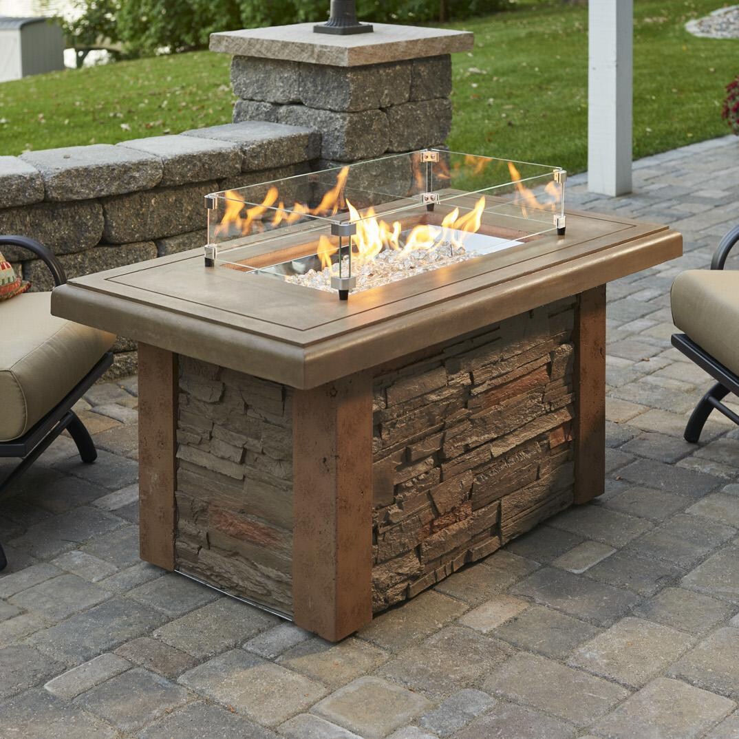 The Outdoor GreatRoom Company Sierra Linear Gas Fire Pit Table - Lifestyle - Glass wind guard pictured is optional accessory thumbnail
