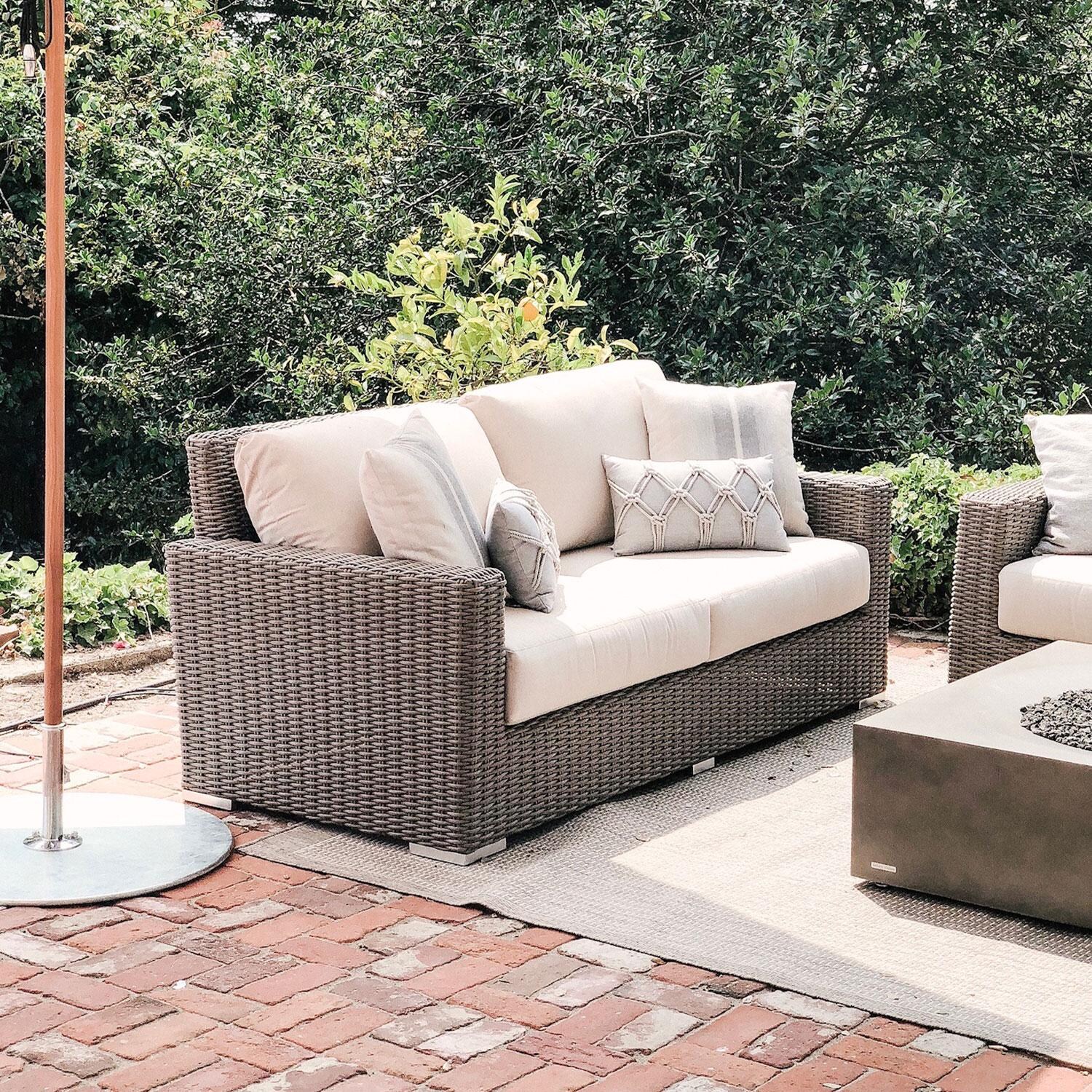 Coronado Wicker Patio Loveseat W/ Sunbrella Canvas Flax Cushions By Sunset West - On Patio - Lifestyle thumbnail