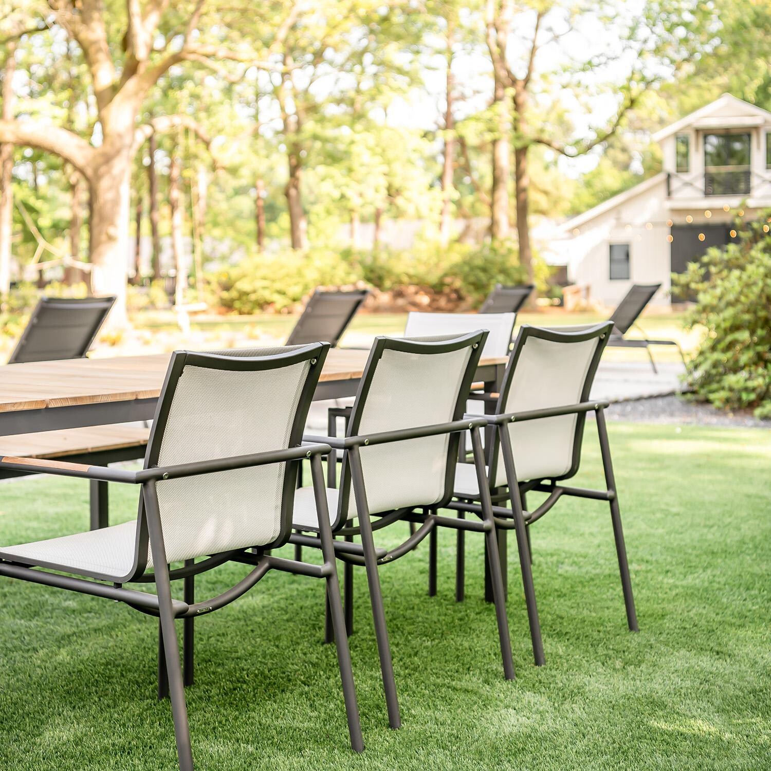 Teak + Table Paros Stacking Dining Chair in Asteroid/White - Dining Table Side View - Lifestyle thumbnail