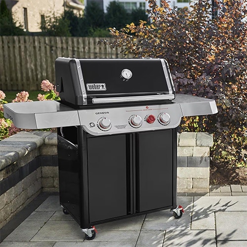 Weber freestanding gas grill on a backyard patio