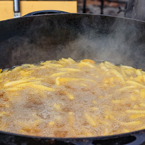Fries in a cast iron deep fryer