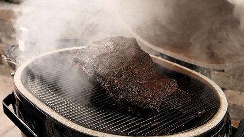 Brisket being smoked on a Primo kamado