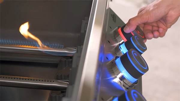 Chef Tony turns one of the burners on to demonstrate the SafetyGlow knob light turning from blue to red.