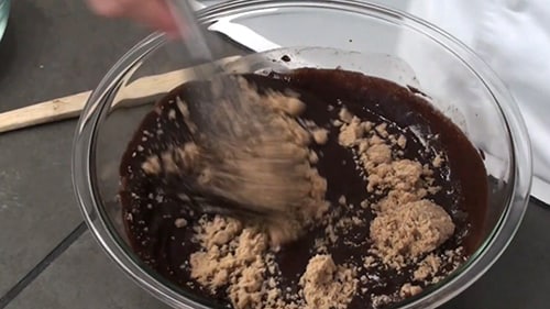 Brown sugar being whisked into the chocolate mixture