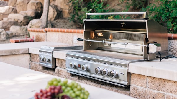 Large outdoor kitchen featuring a built-in Summerset Gas Grill