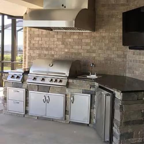 Brick outdoor kitchen with stainless steel appliances