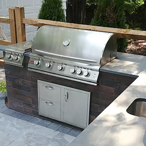 View of the stainless steel Blaze LTE and side burner, as well as the doors and drawers