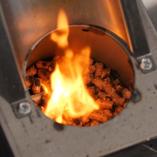 Pellets burning in a pellet grill.