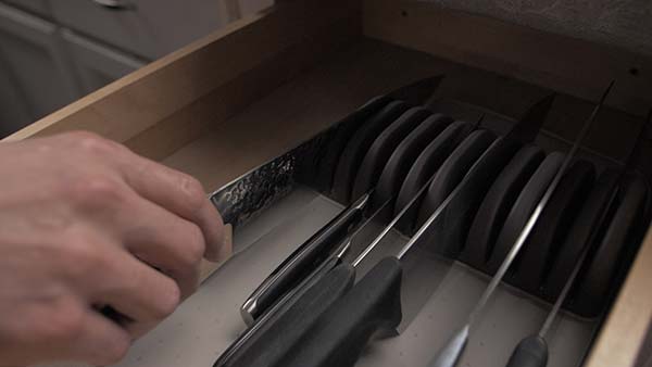 Kitchen knife being being stored in a tray