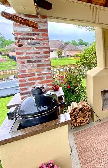 Kamado installed in a built in fixture next to a fireplace