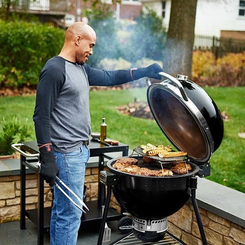 Man cooking on a Weber Kamado