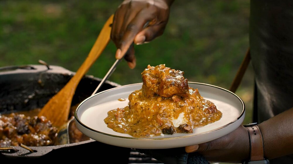 Rasheed serving the stew