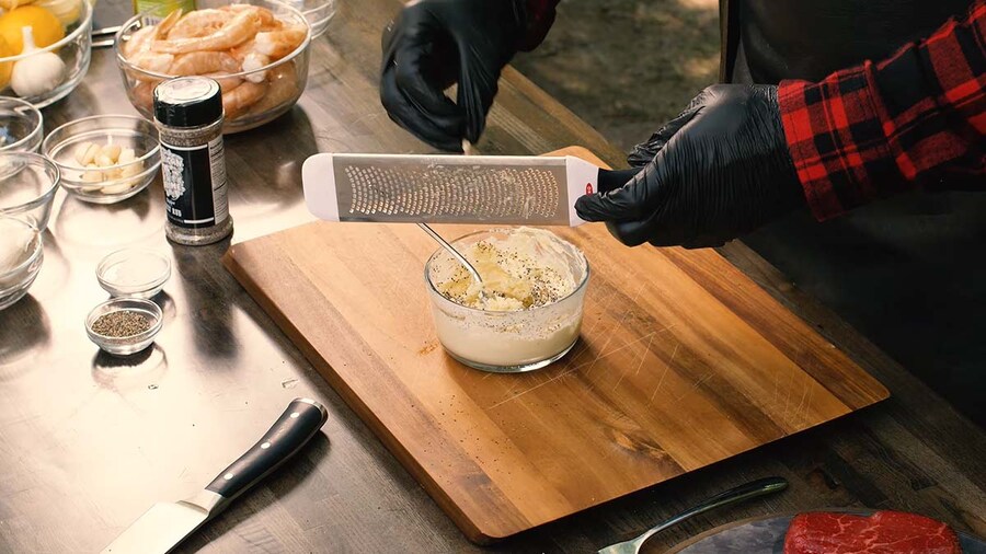 Rasheed microplaning garlic into his compound butter