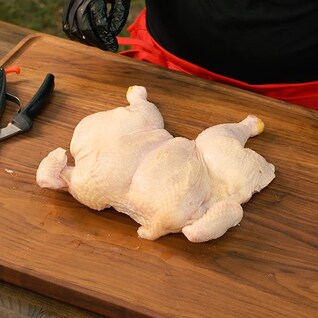 Kelsey Heidkamp showing off the trimmed and tucked chicken