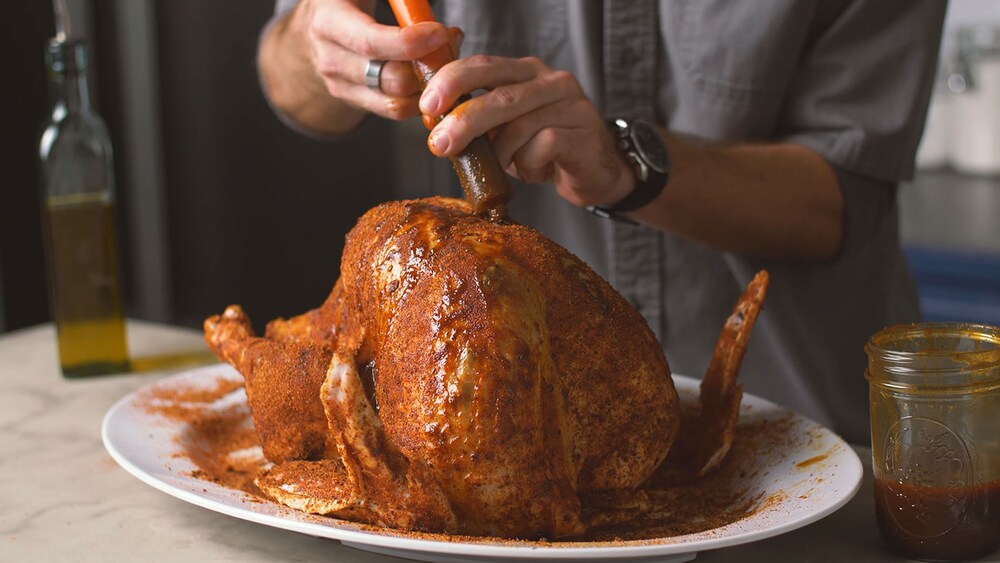 Cajun fried turkey being injected before frying
