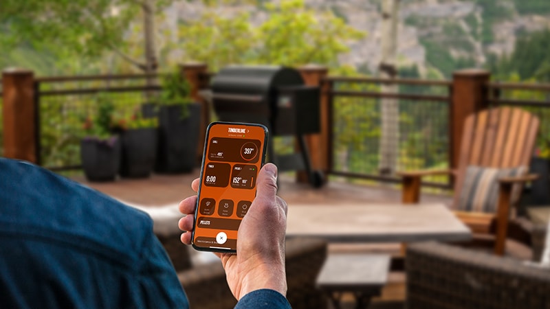Traeger WiFire controller app on a smartphone for remote controls