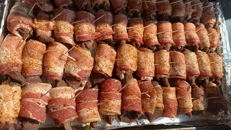 Bacon-wrapped appetizers prepped on a foil lined sheet pan