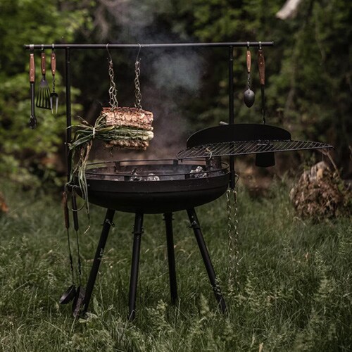 food cooking on freestanding wood-fired grill