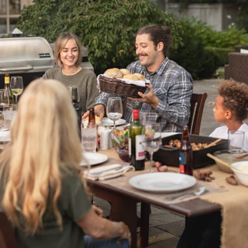 blended family gathering at an outdoor dining table