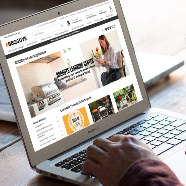 Person on laptop browsing BBQGuys Learning Center