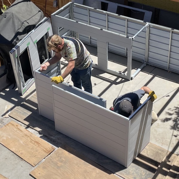 professionals assembling an outdoor kitchen island