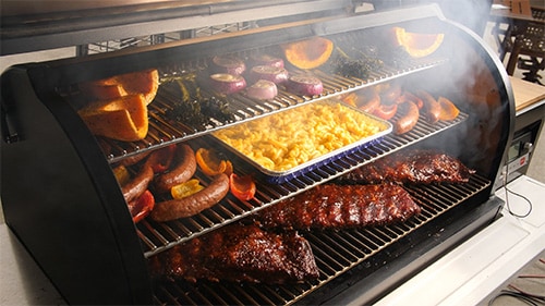 Ribs, sausage, vegetables, and casserole in a pellet grill