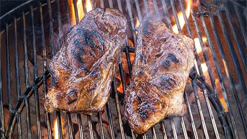 pork steaks on a charcoal grill