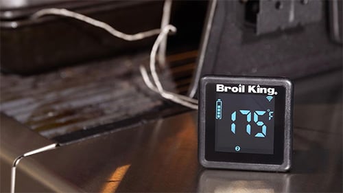 digital thermometer in front of gas grill