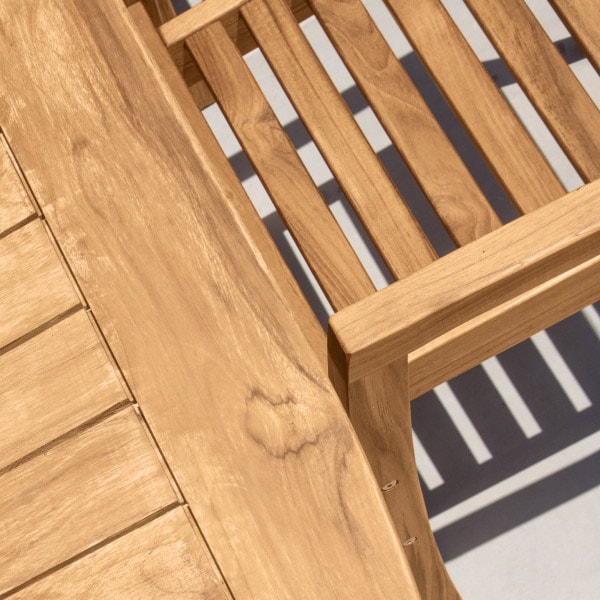 Close-up photograph of premium Grade A teak wood grain showing rich color and dense natural wood structure