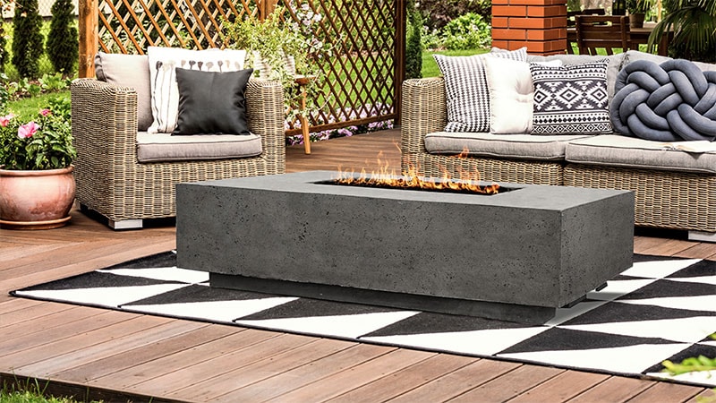 outdoor patio with sectional, chair, and fire pit table