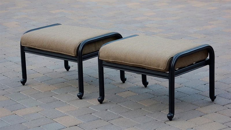 2 outdoor ottomans on stone patio