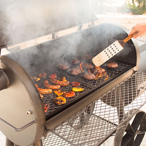 food cooking on an open traditional offset smoker