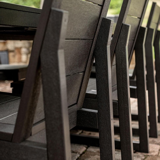 Close-up of dark brown poly lumber dining chairs and table on an outdoor patio