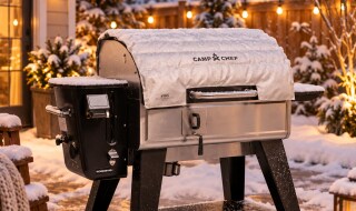 Camp Chef pellet grill with a fitted Camp Chef insulated blanket in a snowy backyard