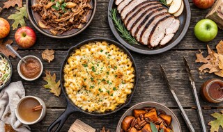Fall smoked food spread with pulled pork, sliced smoked turkey breast, smoked mac and cheese, and bourbon-glazed sweet potatoes